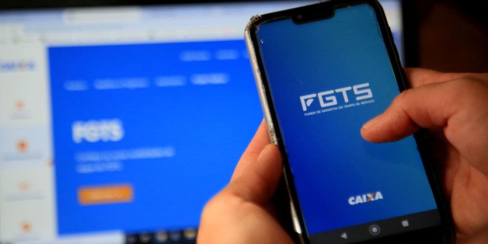 salvador, bahia, brazil - december 8, 2020: person with cell phone trying to access the FGTS page on the Caixa Economica Federal website in the city of Salvador.